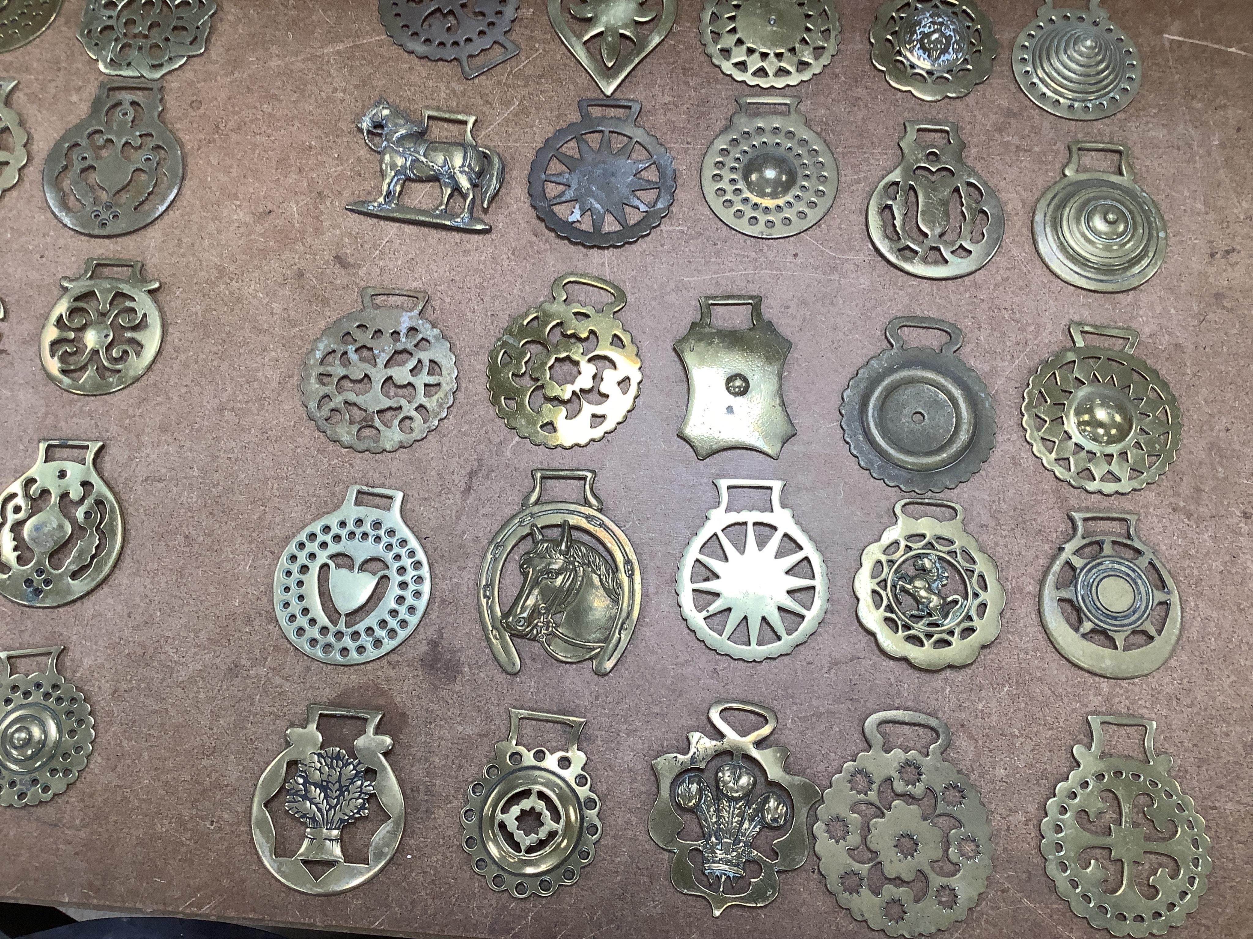 A collection of various horse brasses